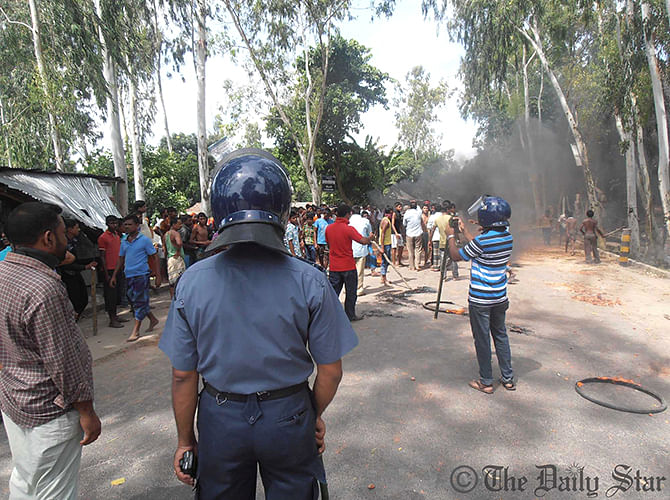 Law enforcers take position during a deadly clash between people of two villages in Kurigram Sadar upazila on Thursday. Photo: Star