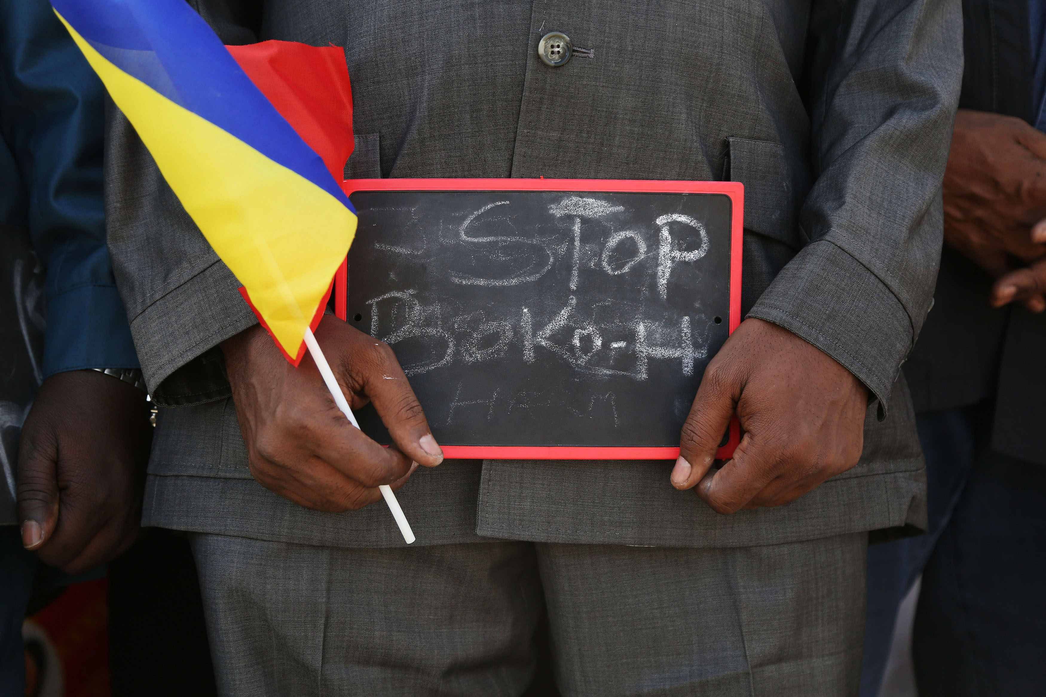 A man holds a sign that reads "Stop Boko Haram" at a rally to support Chadian troops heading to Cameroon to fight Boko Haram, in Ndjamena January 17, 2015. Photo: Reuters