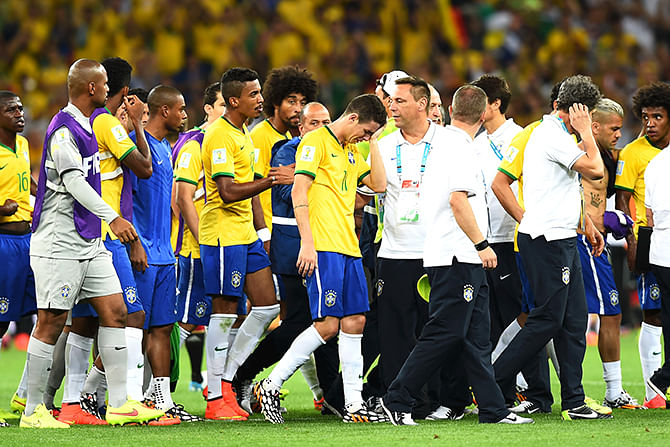 Oscar of Brazil (center) reacts with teammates after being defeated 7-1 by Germany during the 2014 FIFA World Cup Brazil Semi Final match between Brazil and Germany at Estadio Mineirao on July 8, 2014 in Belo Horizonte, Brazil. Photo: Getty Images