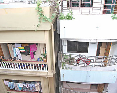 This Star file photo shows a six-storey building, right, tilted towards the adjoining five-storey building, left, in Chittagong city last year.