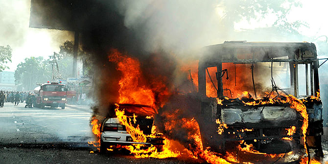 A private car and a state-run BRTC bus burning near Rajuk Bhaban at Gulistan on January 06, 2015. Photo: STAR