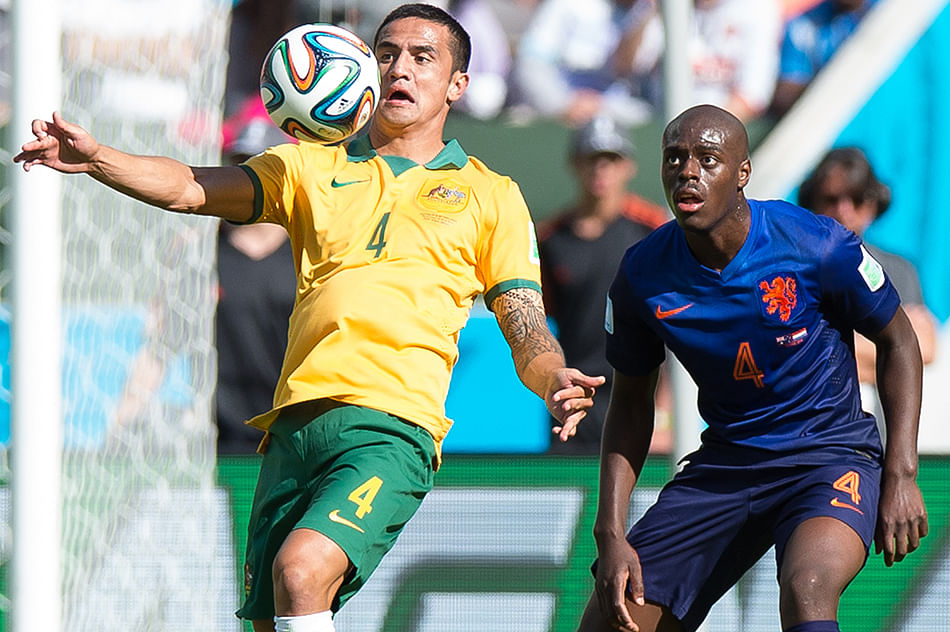 Bruno Martins Indi of the Netherlands and Tim Cahill of Australia compete for the ball during the 2014 FIFA World Cup Brazil Group B match between Australia and Netherlands at Estadio Beira-Rio on June 18, 2014 in Porto Alegre, Brazil. Photo: Getty Images