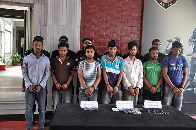 Rapid Action Battalion produce seven carjackers along with money, mobile phones and keys at a press briefing at Rab headquarters in the capital Saturday. Photo: Courtesy