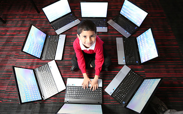 Ayan Qureshi surrounded by computers.Photo taken from The Telegraph website.