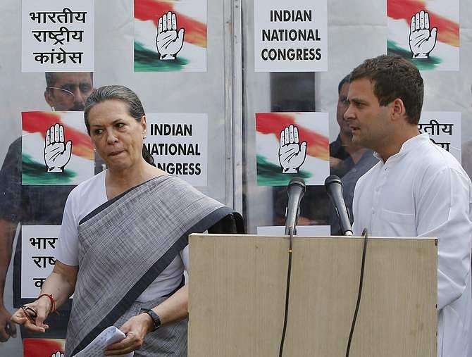 Congress party chief Sonia Gandhi (L) and her son and vice-president of Congress Rahul Gandhi leave after addressing a news conference in New Delhi May 16, 2014. India's Nehru-Gandhi dynasty, the towering force of Indian politics for the best part of a century, faces a fight for its very survival after an election drubbing at the hands of opposition leader Narendra Modi. Photo: Reuters