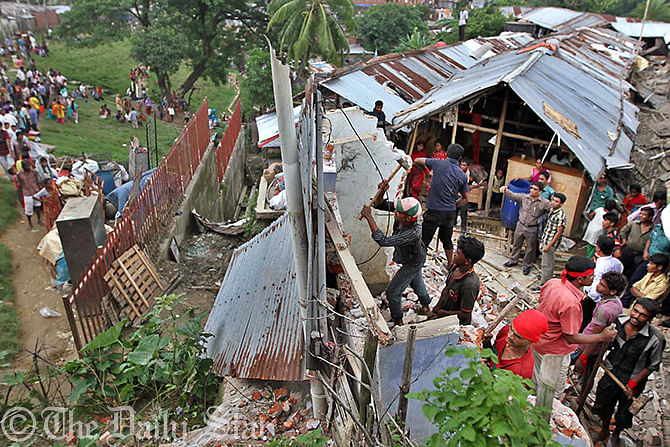 District administration with the help of law enforcers and members of fire service conduct an eviction drive against people living under the threat of landslides at Tankir Pahar in Lalkhan Bazar of Chittagong city. The hilly city faces heavy rainfall this monsoon. Photo: Star