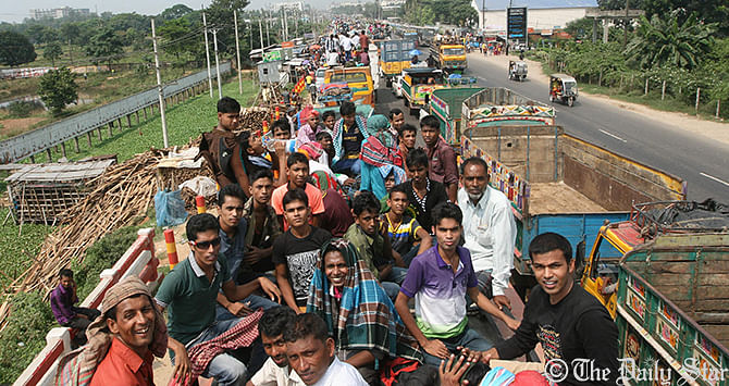 This Star photo taken from the Dhaka-Tangail highway on Friday shows the road packed with buses and other vehicles overcrowded with home-goers. Photo: Palash Khan