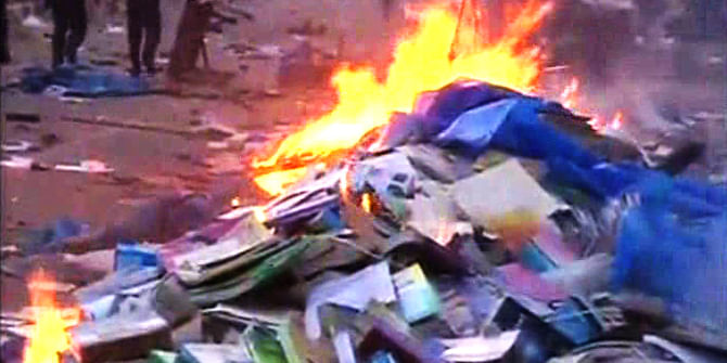 DU students set fire to several makeshift bookshops set up on the footpaths outside of book market in Nilkhet of the capital during a clash with booksellers Saturday afternoon. Photo: TV grab