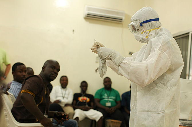 A Samaritan's Purse medical personnel demonstrates personal protective equipment to educate team members on the Ebola virus in Liberia in this undated handout photo courtesy of Samaritan's Purse. Photo: Reuters
