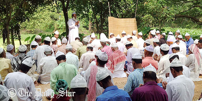 Dr Monirul Islam delivers his sermon in an Eid congregation at Shilai village in Munshiganj on Saturday. Photo: Star   