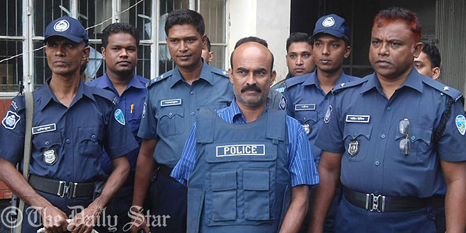 Police handcuff Awami League leader Belal Hossain Patwari (centre) after his arrest Thursday in Khagrachhari for his alleged link with Phulgazi upazila chairman Ekramul Haq. Photo: STAR
