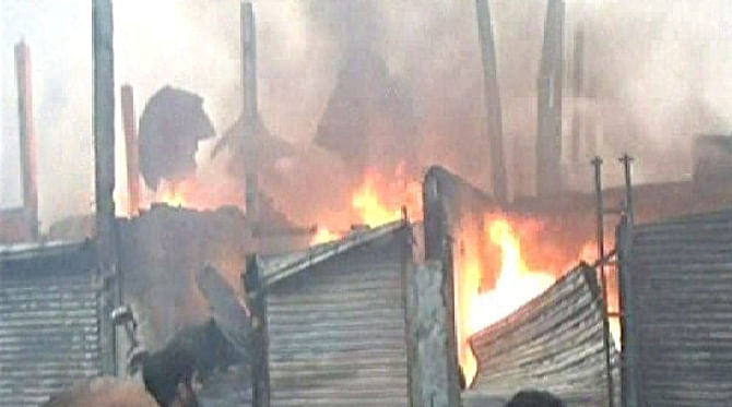 At least 100 shops of the tin-shed Shuhrawardi Market in Narayanganj city burnt Wednesday morning after a fire breaks out there. Photo: TV grab 