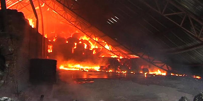Fire engulfs the tin-shed building of Jaba Textile Mill in Brammandi area of Narsingdi town this morning. Photo: Star
