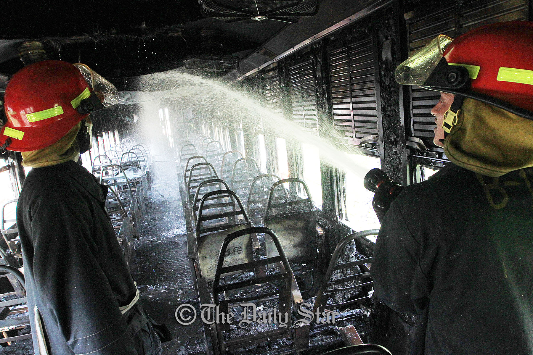 Firefighters douse the fire engulfed in Kalni Express train at Cantonment Railway Station in the capital Tuesday afternoon. Photo: Polash Khan