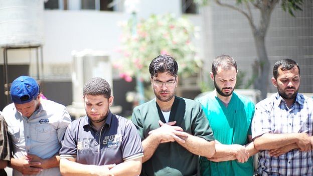  Medics at Shifa hospital pause during their work to make a collective prayer. The photo is taken from BBC Online. 
