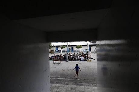 Palestinians listen to a sermon as they pray in the courtyard of a U.N. school in Gaza City, Monday. Photo: AP