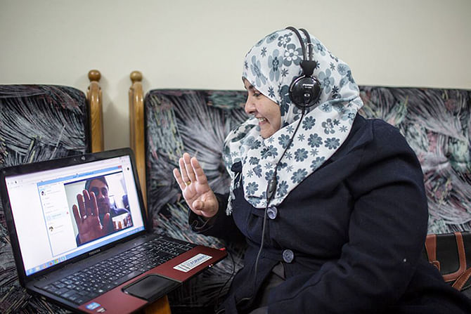 Shurrab speaks with Faddah via Skype. Since Hamas took power in Gaza, exit into Israel has been strictly limited. Photo: New York Times