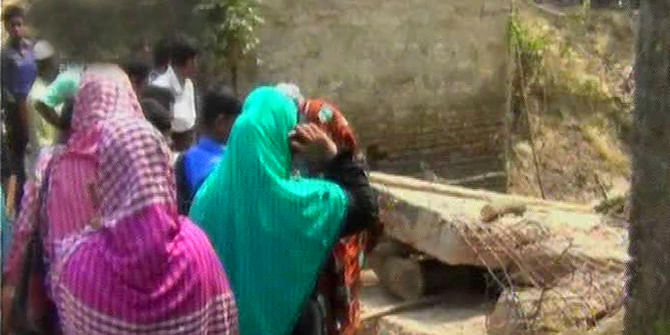 Local people gather near a collapsed under construction bridge at Barun village in Kapasia of Gazipur on Thursday. Four construction workers died and three others were injured when they were demolishing old bridge there. Photo: TV grab