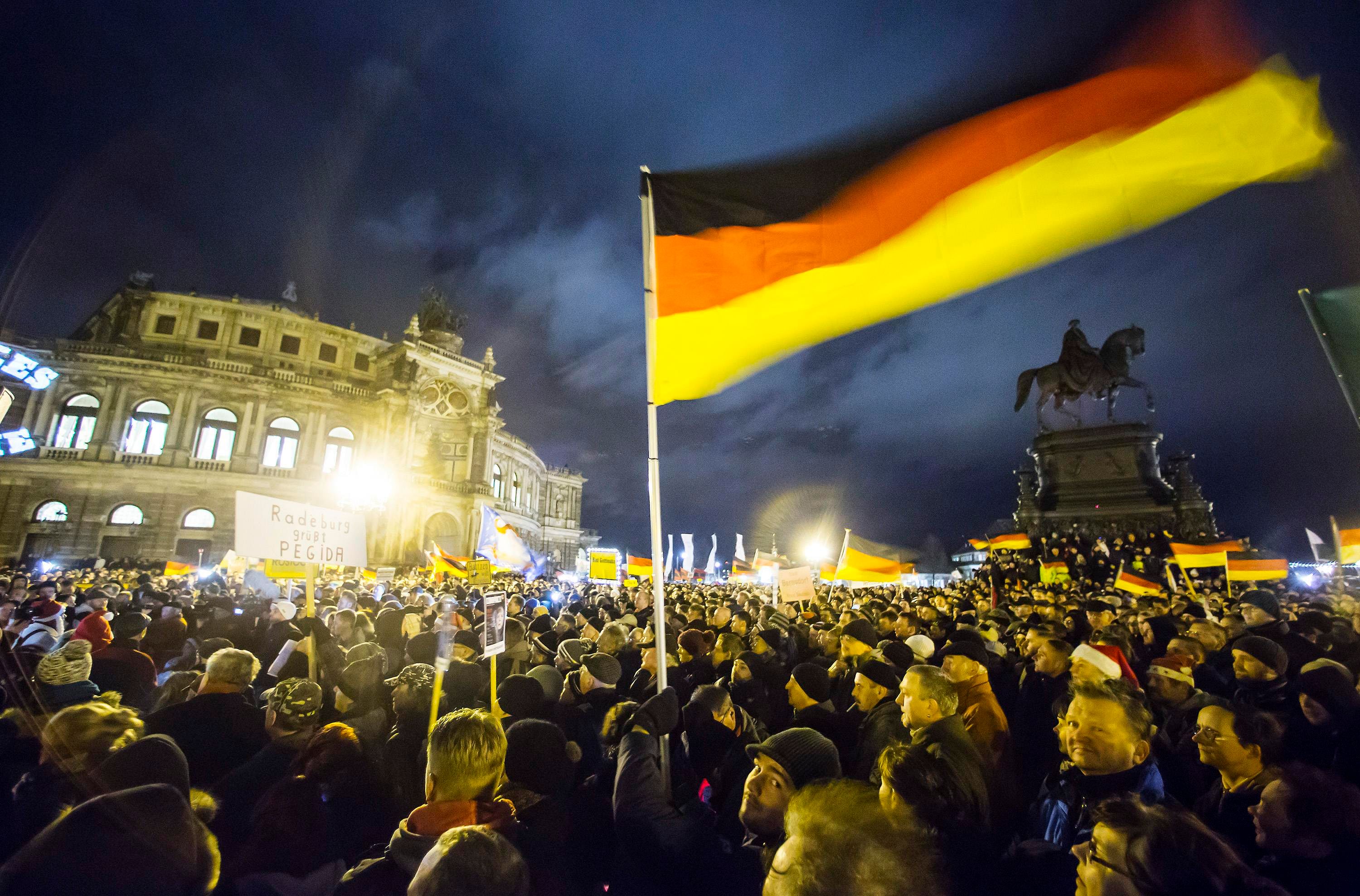 Participants hold German national flags during a demonstration organised by anti-immigration group PEGIDA, a German abbreviation for 