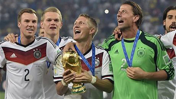 Germany's Bastian Schweinsteiger celebrates with the trophy after the World Cup final soccer match between Germany and Argentina at the Maracana Stadium in Rio de Janeiro, Brazil, Sunday, July 13, 2014. Germany won the match 1-0. Photo: AP 