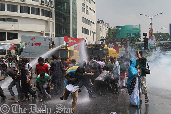 Police use water canon to disperse Gonojagoron Mancha activists Wednesday morning at Shahbagh intersection where they gather protesting verdict of the Supreme Court that commutes death sentence of Jamaat leader Sayedee to imprisonment till death. Photo: Amran Hossain