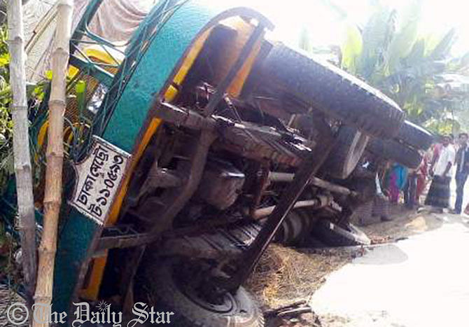 A truck overturns after it ploughed through a house killing two people on the spot at Kashiani in Gopalganj on Monday. Photo: STAR