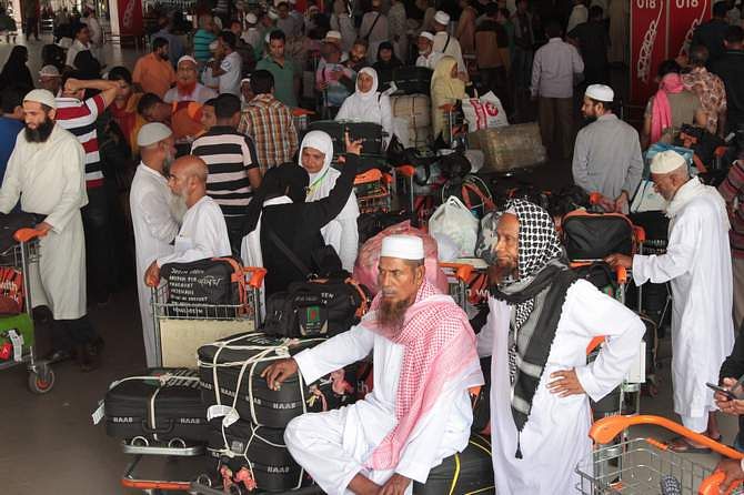 This October 28, 2013 photo shows a group of Hajj pilgrims waiting at Hazrat Shahjalal International Airport in Dhaka. Photo: Star