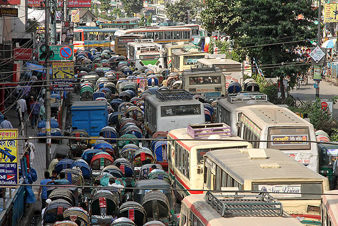 Many vehicles are seen on a road at Paltan in Dhaka on Sunday defying the second phase hartal enforced by Jamaat-e-Islami. Photo: TV grab