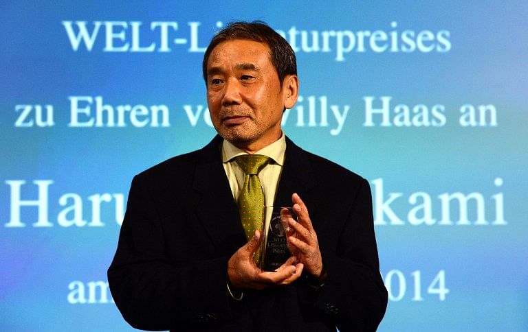 Japanese writer Haruki Murakami poses with his trophy prior to an award ceremony for the Germany's Welt Literature Prize bestowed by the German daily Die Welt, in Berlin on November 7, 2014. Photo: AFP/ John Macdougall