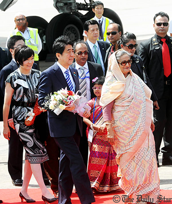 Prime Minister Sheikh Hasina receives Japanese Prime Minister Shinzo Abe and his wife at Hazrat Shahjalal International Airport at 12:56pm on Saturday. Photo: Star