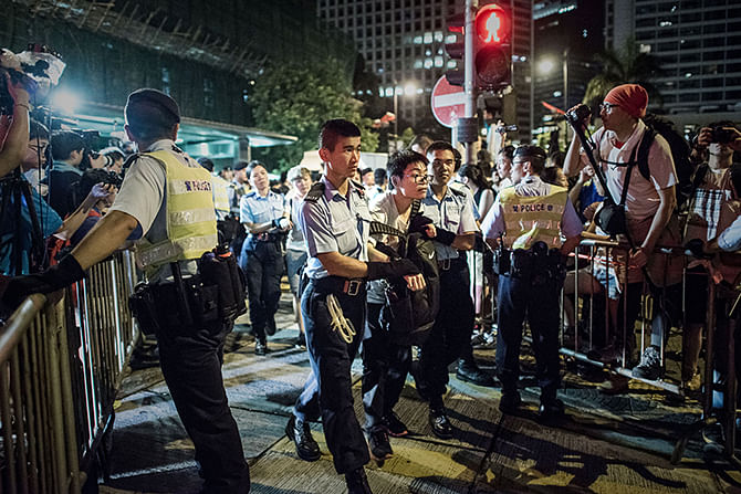Policemen remove protesters in the central district after a pro-democracy rally seeking greater democracy in Hong Kong early on July 2, 2014 as frustration grows over the influence of Beijing on the city. Scores of protesters were forcibly removed by police in the early hours following a massive pro-democracy rally which organisers said saw a turnout of over half a million. Photo: Getty Images
