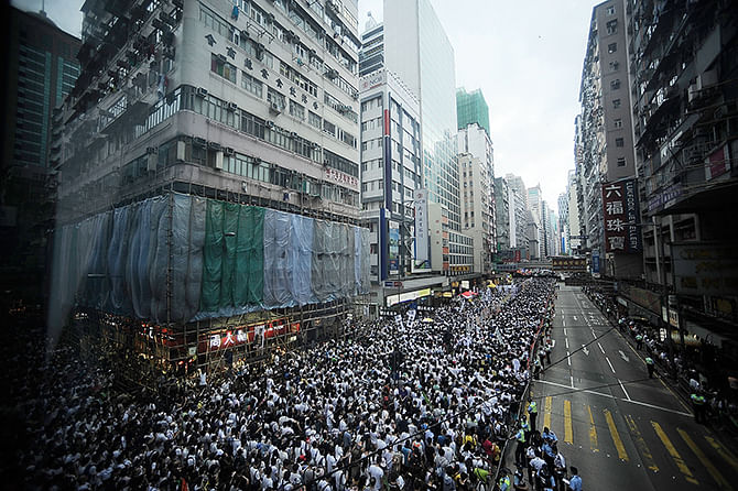 People march on a street during the annual pro-democracy protest on July 1, 2014 in Hong Kong. Photo: Getty Images