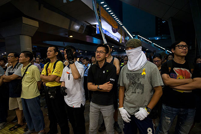 Protesters of the Occupy Central movement stand guard outside an area blocking the entrance to government headquarters in Admiralty district in Hong Kong October 7, 2014. Photo: Reuters