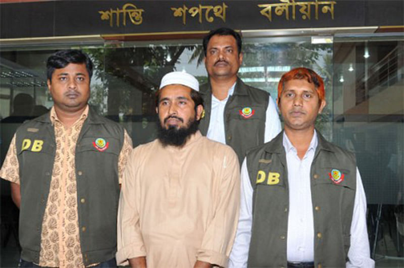Detectives places banned militant outfit Harkat-ul-Jihad-al-Islami (Huji) top Huji operative, Khairul Bashar, alias Ibrahim, before journalists at a press briefing at Dhaka Metropolitan Police (DMP) media centre in Dhaka on Wednesday. Photo: STAR 