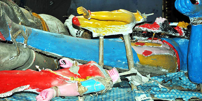 The damaged idols are seen lying on a makeshift stage inside Korkola Kali Mondir in Chatmohar upazila of Pabna. Photo: Star