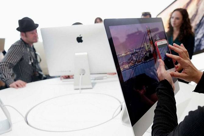 A new iMac is photographed at Apple headquarters on Thursday, Oct. 16, 2014 in Cupertino, Calif. Apple released an update to its Mac operating system and introduced the high-resolution iMac model that might appeal to heavy watchers of television over the Internet. Photo: AP/ Marcio Jose Sanchez
