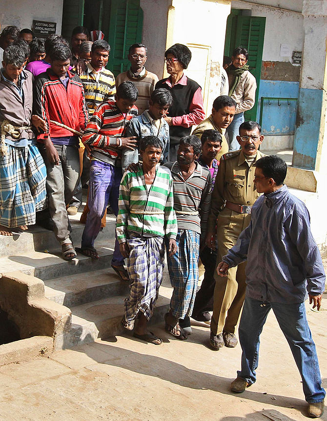 Indian police personnel escort men (tied with rope), who are accused of gang-rape, from a court at Birbhum district in the eastern Indian state of West Bengal January 23, 2014. A 20-year-old woman in eastern India was gang-raped by 13 men on the orders of a village court as punishment for having a relationship with a man from a different community, a senior police officer said on Thursday. The woman, who is now recovering in hospital, told police she was assaulted by the men on the night of Jan. 20 in Birbhum district in West Bengal.