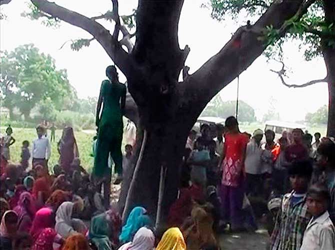 Two girls are seen hanging from a tree in a village in the northern Indian state of Uttar Pradesh on Thursday. Photo: Reuters