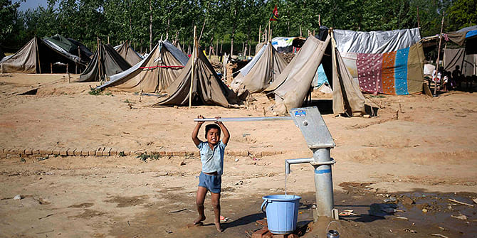 A displaced child fills a water bucket using a hand pump at a relief camp in the village of Kutba at Muzaffarnagar, affected by 2013 riots, in the northern Indian state of Uttar Pradesh on Wednesday. Indian general election is being held in 91 seats in 14 states, including in the capital Delhi and the key state of Uttar Pradesh. Photo: Reuters