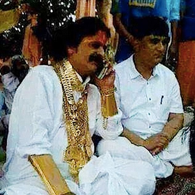 The wedding took place in the city of Tirupati in Andhra Pradesh, with the father of the bride - whose name is not known - almost upstaging his daughter by showing off his own huge gold chain collection.