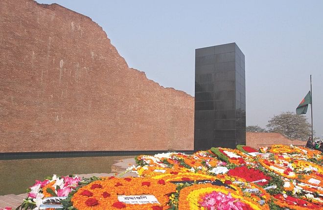 Wreaths from people of all walks of life adorn the altar of the memorial at Rayerbazar killing field in the capital on Martyred Intellectuals Day on December 14, 2013.