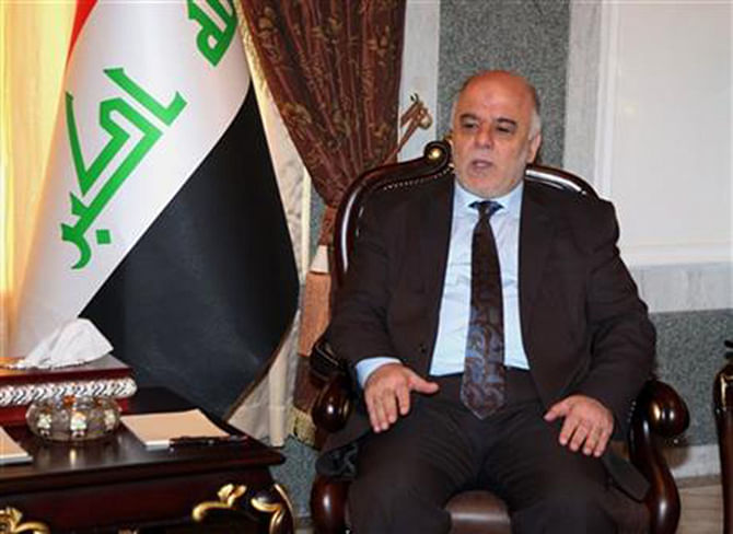 Iraqi premier-designate Haider al-Abadi meets with Pastor Farouk Yousuf in Baghdad, Iraq, Thursday, Aug. 21, 2014. Al-Abadi has until Sept. 11 to submit a list of Cabinet members to parliament for approval. Religious and ethnic minorities have called upon him to assemble an all-inclusive government. Photo: AP