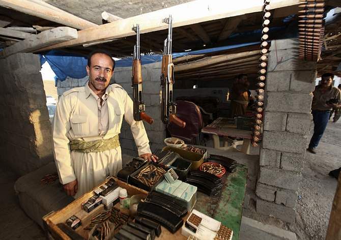 A Kurdish man displays weapons for sale at an arms market in Arbil, capital of the autonomous Kurdish region of northern Iraq, August 17, 2014. The White House said on Sunday that President Barack Obama had informed Congress he authorized US air strikes in Iraq to help retake control of the Mosul Dam, which it said was consistent with his goal of protecting US citizens in the country. Photo: Reuters