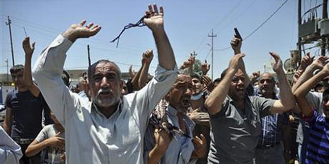 In this June 23, 2014, photo, mourners chant slogans against the al-Qaida breakaway group Islamic State of Iraq and the Levant after they bury 15 bodies in the village of Taza Khormato near the northern oil-rich city of Kirkuk, Iraq. Photo: AP