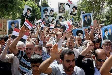 Iraqis living in Iran hold a demonstration against Sunni militants of the al-Qaida-inspired Islamic State of Iraq and the Levant, or ISIL, and to support the Grand Ayatollah Ali al-Sistani, Iraq's top Shia cleric, shown in the posters, as some of them hold posters of the Iranian Supreme Leader Ayatollah Ali Khamenei, in Tehran, on June 20. Photo: AP 