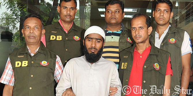 Detectives bring Hafizur Rahman, arrested for his suspected link with Islamic Militants, before the media at DMP headquarters in Dhaka on Friday. Photo: Firoz Ahmed 