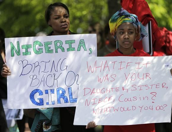Protesters hold signs during a march in support of the girls kidnapped by members of Boko Haram. Photo: Reuters