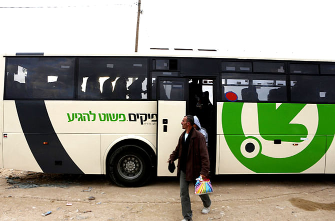 Palestine worker gets down from an Israeli bus. Photo: Reuters