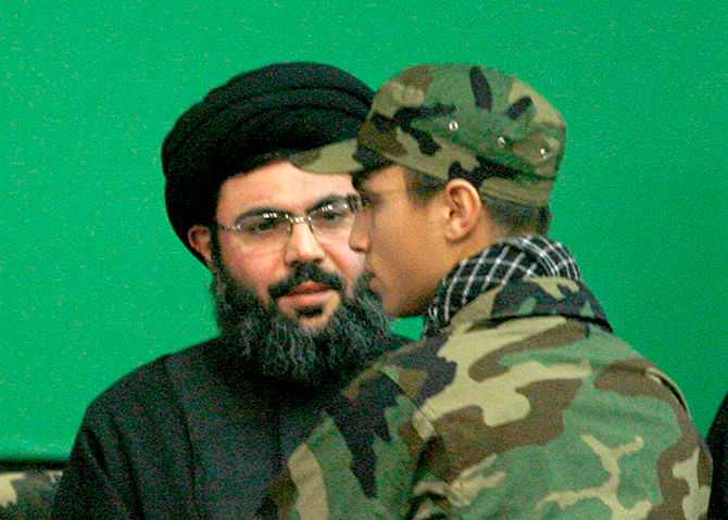 This Reuters photo taken on February 22, 2008 shows Jihad Moughniyah (R), son of Lebanon's Hezbollah late military leader Imad Moughniyah, greeting Sayyed Hashem Safieddine, head of Hezbollah's Executive Council, as they attend a ceremony marking a week of his father's death in Beirut's suburbs.