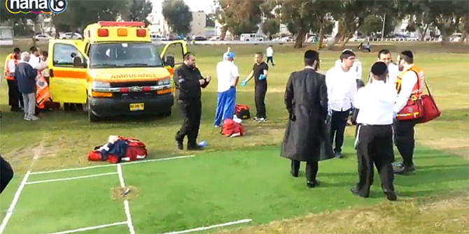 Medical personnel at the scene of an Ashdod cricket game, in which an umpire died after he was hit by the ball, November 29, 2014. Photo taken from Times of Israel/ Channel 10 screenshot